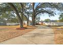 A quaint home with mature trees, brick accents, and a driveway leading to its welcoming entrance at 910 Edgedale Cir, Brandon, FL 33510