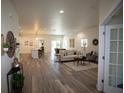Bright, open-concept living space with stylish furnishings and hardwood floors at 9445 Eldridge Rd, Spring Hill, FL 34608