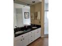 Bathroom with double sinks, granite countertop, white cabinets, and a separate shower at 9636 Greenbank Dr, Riverview, FL 33569