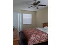 Comfortable bedroom with a ceiling fan, window with blinds, and a cozy bed at 9636 Greenbank Dr, Riverview, FL 33569