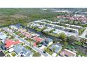 Aerial view of a waterfront community with canals, docks, and various home styles amidst lush greenery at 9826 Island Harbor Dr, Port Richey, FL 34668