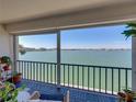 Enjoy the calming water views from this comfortable outdoor balcony with seating at 7910 Sun Island S Dr # 301, South Pasadena, FL 33707