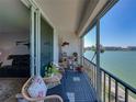 Inviting balcony overlooking the water with chairs and relaxing place to take in the ocean views at 7910 Sun Island S Dr # 301, South Pasadena, FL 33707