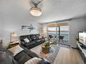 Cozy living room showcasing water views from the adjacent balcony and comfortable seating arrangement at 7910 Sun Island S Dr # 301, South Pasadena, FL 33707