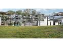 Lush green backyard with a private dock, perfect for relaxing and accessing the beautiful waterways at 104 Carlyle Cir, Palm Harbor, FL 34683