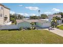 Charming single-story home with a well-maintained lawn and an attached two-car garage at 104 Carlyle Cir, Palm Harbor, FL 34683