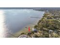 Beautiful waterfront home with private dock access, nestled amidst lush greenery and overlooking the serene bay at 116 Shore Drive Pl, Oldsmar, FL 34677