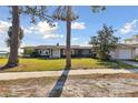 Charming single-story home with a well-manicured lawn, a welcoming entrance, and an attached garage at 116 Shore Drive Pl, Oldsmar, FL 34677