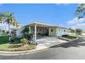 Well-maintained home exterior with a carport, manicured lawn, and attractive landscaping at 12501 Ulmerton Rd # 10, Largo, FL 33774