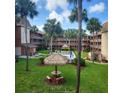 View of the community pool and recreational area, surrounded by palm trees at 12760 Indian Rocks Rd # 540, Largo, FL 33774