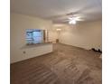 View of open-concept living room showing neutral carpet and kitchen view at 12760 Indian Rocks Rd # 540, Largo, FL 33774
