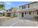 Two story townhome featuring neutral paint scheme, black shutters and ample parking spaces at 156 Douglas W Rd # C, Oldsmar, FL 34677