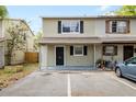 Two story townhome featuring neutral paint scheme, black shutters and ample parking spaces at 156 Douglas W Rd # C, Oldsmar, FL 34677