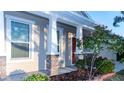 Inviting front porch with stone accents and meticulous landscaping details at 1705 Bonita Bluff Ct, Ruskin, FL 33570
