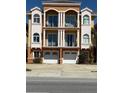 Beautiful three-story townhome featuring balconies and two garage doors at 17821 Gulf Blvd # B, Redington Shores, FL 33708