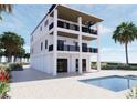 A stylish white home features a pool, multi-level balconies, and well-manicured tropical landscaping at 2004 Gulf Blvd, Indian Rocks Beach, FL 33785