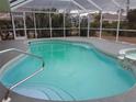 Sparkling screened-in pool and spa, perfect for relaxation and entertaining at 26 Clintwood Ave, Englewood, FL 34223
