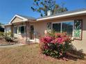 Home's entrance featuring decorative shutters and landscaping at 2850 41St N St, St Petersburg, FL 33713