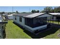 Aerial view of single-story home with screened porch and carport in a well-maintained community at 37542 Pinata Ave, Zephyrhills, FL 33541