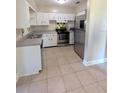 Bright kitchen featuring stainless steel appliances and white cabinetry at 3905 W Carmen St, Tampa, FL 33609