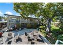 Outdoor patio with multiple seating areas, perfect for entertaining or relaxing in a lush landscaped setting at 426 32Nd N Ave # 102E, St Petersburg, FL 33704