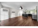 Open concept living area features sleek wood floors and a modern stainless steel kitchen at 426 32Nd N Ave # 102E, St Petersburg, FL 33704