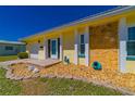 Quaint yellow home with stone accents and charming turtle ornaments in a rock garden at 5427 Springwood Blvd # 5427, Pinellas Park, FL 33782