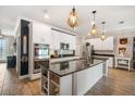 Bright kitchen features white cabinetry, stainless steel appliances, and pendant lighting at 7515 37Th E Ave, Palmetto, FL 34221