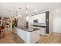 Bright kitchen featuring white cabinetry, granite countertops and modern chandeliers at 7515 37Th E Ave, Palmetto, FL 34221