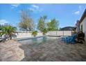 Backyard pool area with brick pavers and white fence at 7515 37Th E Ave, Palmetto, FL 34221