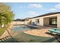 Relaxing pool area featuring brick pavers, poolside seating, and a hammock for enjoying sunny days at 7515 37Th E Ave, Palmetto, FL 34221