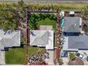 Aerial view of home with a well-maintained lawn and tropical landscaping in a beautiful neighborhood at 7942 Causeway N Blvd, St Petersburg, FL 33707