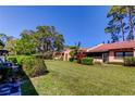 Expansive backyard featuring lush green lawn, mature landscaping, and serene outdoor space for relaxation at 9769 86Th Ave # 9769, Seminole, FL 33777