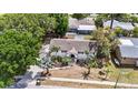 Aerial view of a single-Gathering home showcasing landscaping, roof, and neighborhood at 1037 Jamaica Way, Tarpon Springs, FL 34689