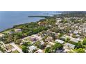 Scenic aerial view of waterfront homes with lush foliage near a tranquil bay at 1037 Jamaica Way, Tarpon Springs, FL 34689