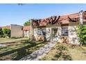 Charming townhome with a well-maintained lawn and a welcoming walkway to the front door at 11511 113Th St # 22E, Largo, FL 33778