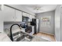 Cozy kitchen features stainless steel appliances and white cabinets at 11511 113Th St # 22E, Largo, FL 33778