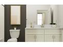 Elegant bathroom featuring a marble countertop and modern gold framed mirror at 11707 Lilac Pearl Ln, Parrish, FL 34219