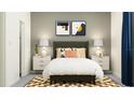 Cozy bedroom with decoratively patterned rug, neutral walls, and bedside lamps at 11861 Sparkling Topaz Cv, Parrish, FL 34219