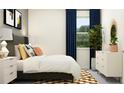 A bedroom with a comfortable rug, neutral walls, bedside lamps, and bright window at 11861 Sparkling Topaz Cv, Parrish, FL 34219