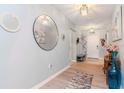 Inviting foyer with wood floors, modern lighting fixtures, and decorative mirrors at 12103 Gothic Rd, Spring Hill, FL 34610