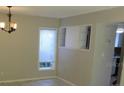 Dining area featuring tile flooring, bright window, and chandelier lighting at 12611 Touchton Dr # 122, Tampa, FL 33617
