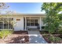 Inviting front porch with rocking chairs and a well-manicured garden at 1433 Park N St, St Petersburg, FL 33710