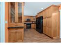 Traditional kitchen with granite countertops, wood cabinets, and stainless steel appliances at 1521 San Helen Dr, Dunedin, FL 34698