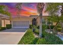 Charming single-story home features tropical landscaping and a patterned driveway at 1647 Emerald Dunes Dr, Sun City Center, FL 33573