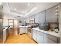 Well-equipped kitchen with modern stainless steel appliances, stylish backsplash, and ample counter space at 3219 Spanish Moss Ln, Palm Harbor, FL 34684