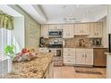 Well-equipped kitchen with granite countertops, stainless steel appliances, and ample cabinet space at 3632 Pine Cone Cir, Clearwater, FL 33760