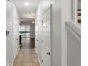 Inviting hallway with tile floors and staircase leading to living area filled with natural light at 4081 71St N Ter, Pinellas Park, FL 33781