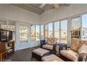 Bright sunroom with large windows, comfortable seating, and views of the surrounding community at 443 Tuna Ct, Oldsmar, FL 34677