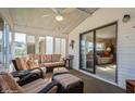 Relaxing sunroom with comfortable seating and an open view into the home's living space at 443 Tuna Ct, Oldsmar, FL 34677